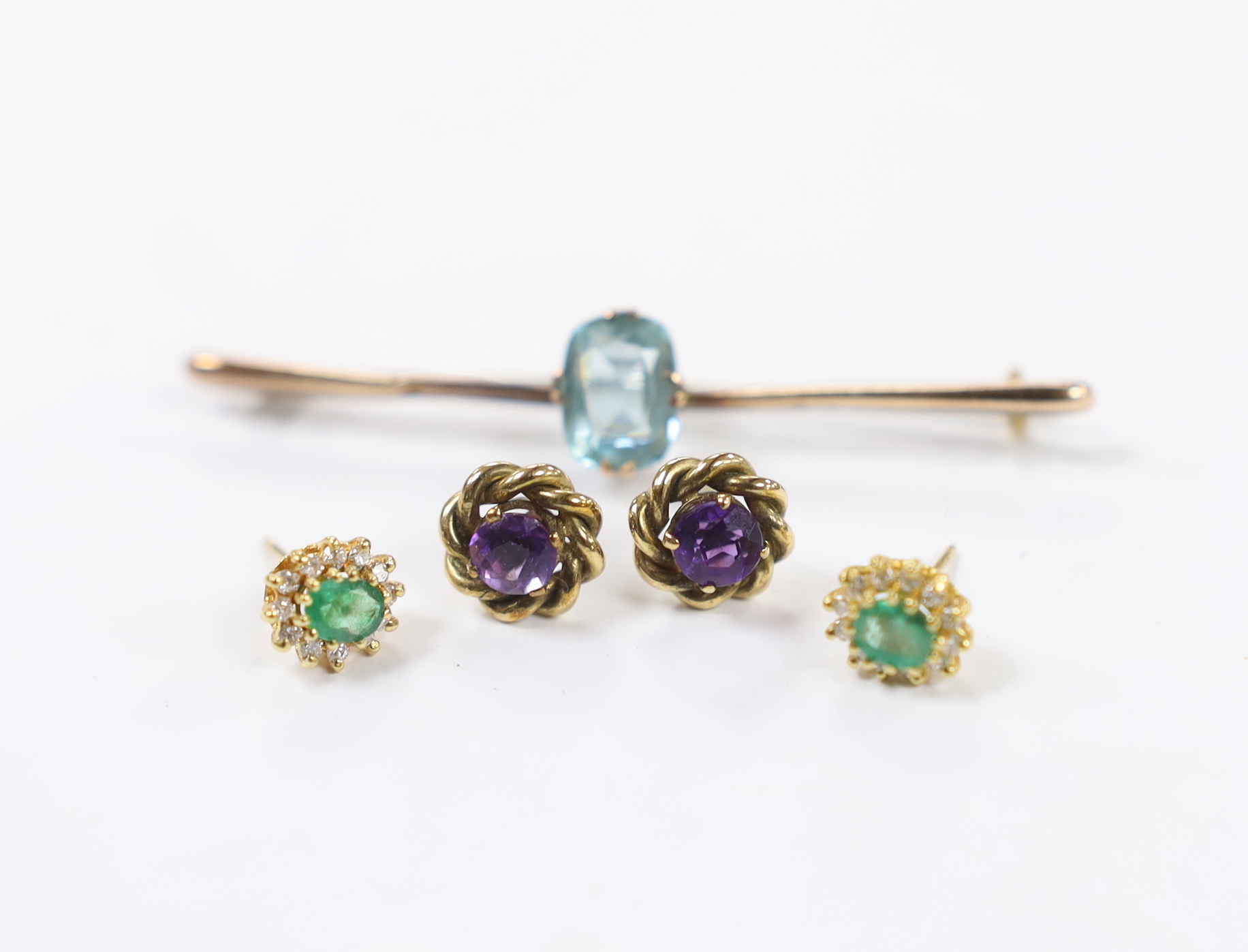 A pair of 18ct gold, emerald and diamond set oval cluster ear studs, one other pair of ear studs (both pairs lacking butterflies) and a 9ct and gem set bar brooch. Fair condition.